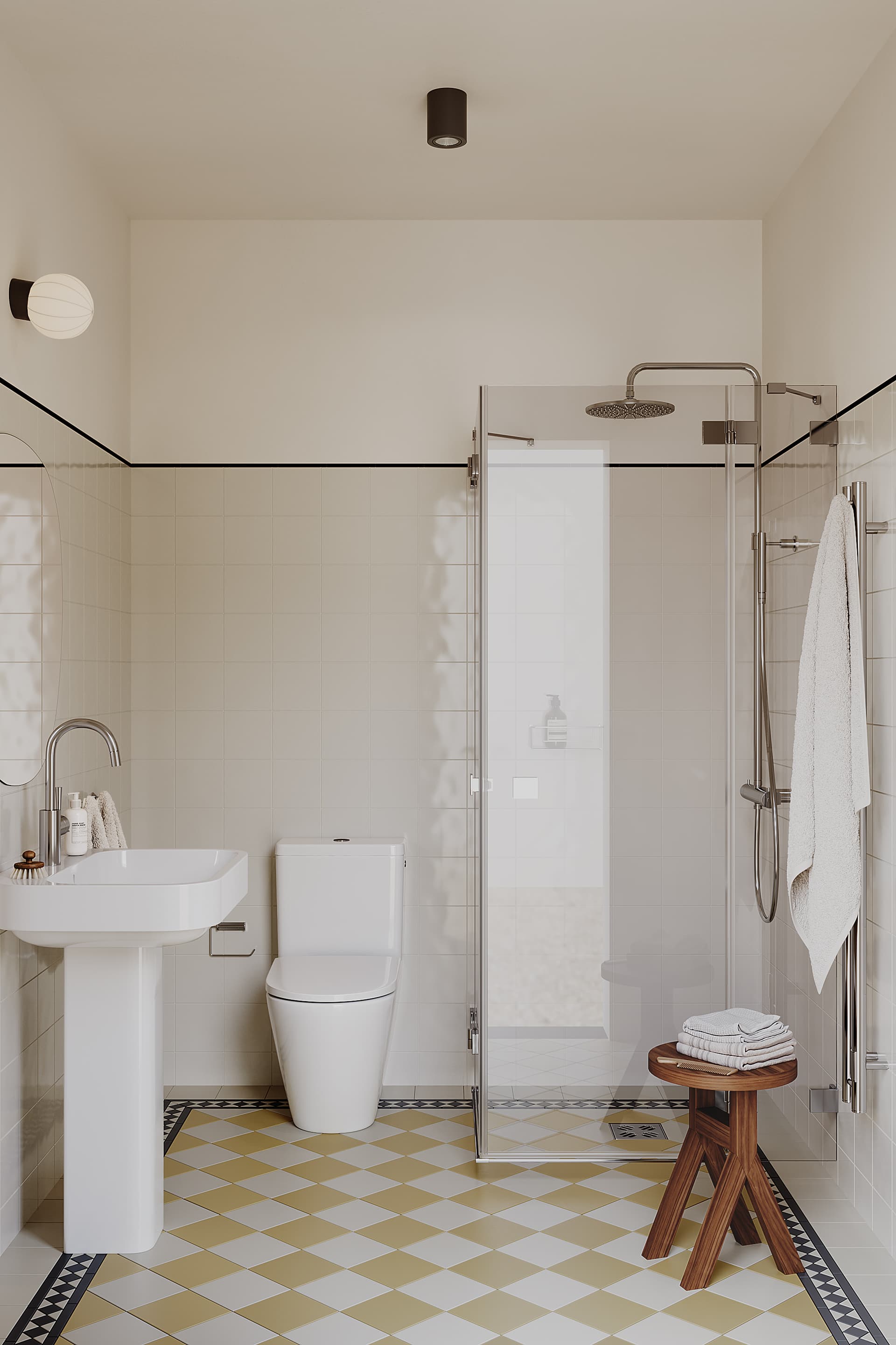 Bright bathroom with classic tiled floor, shower, toilet, and sink.