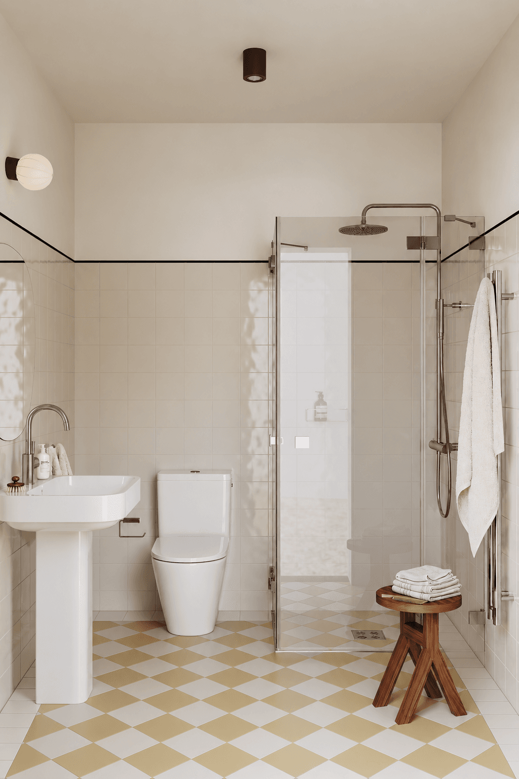 Bright bathroom with classic tiled floor, shower, toilet, and sink.